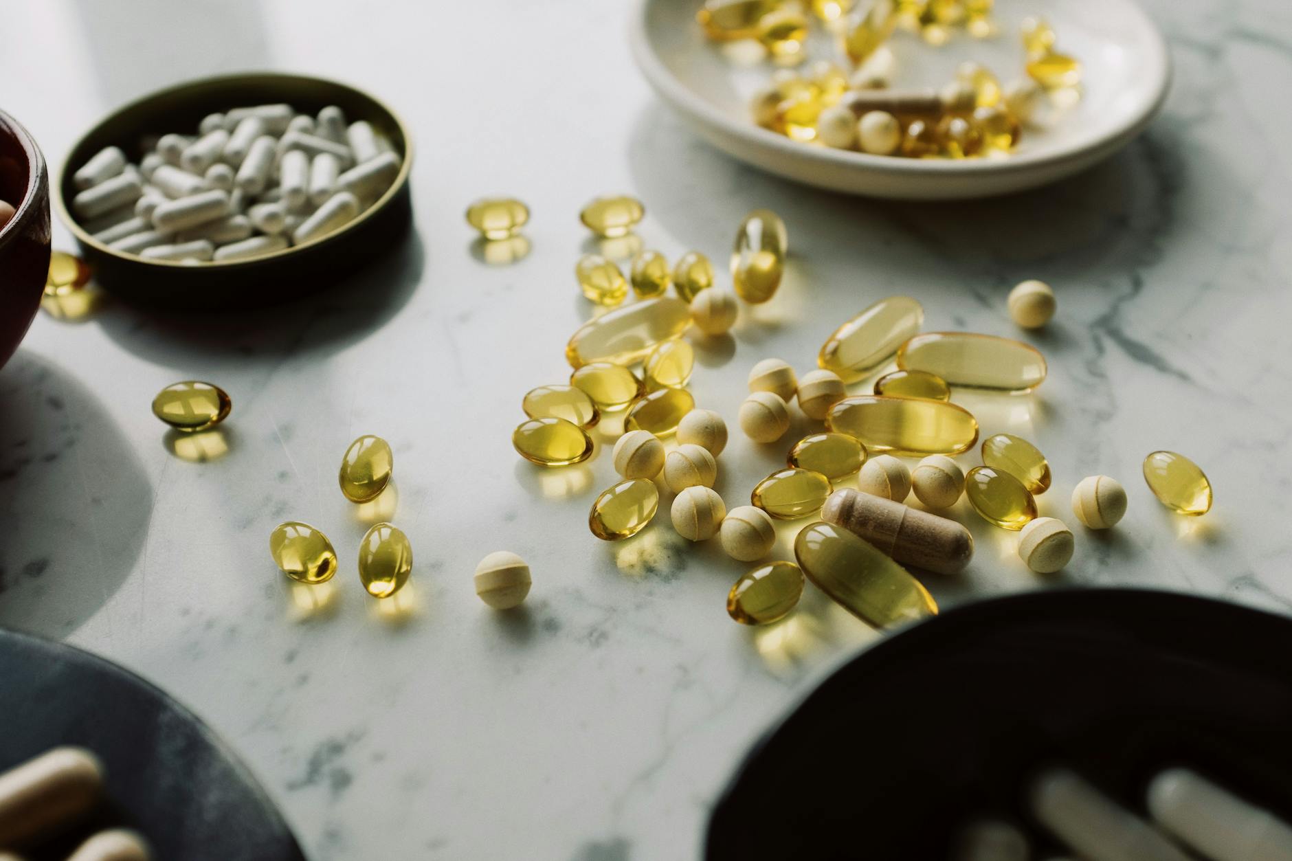 A close-up of assorted pills and supplements arranged on a marble surface, highlighting healthcar... (Photo by ready made on Pexels)